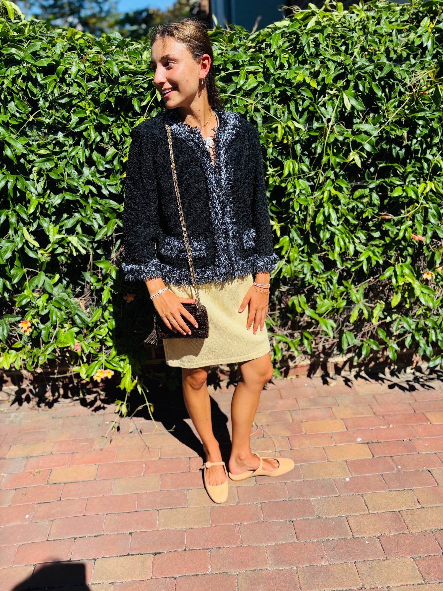 picture of a woman wearing a blue St. John knit blazer and buttercream yellow pencil knit skirt