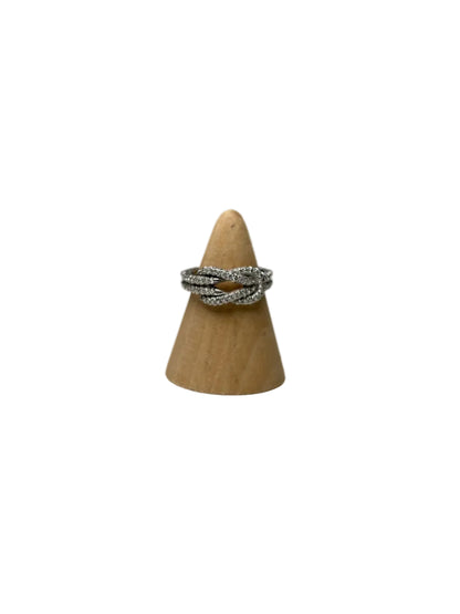 Silver twisted ring with diamonds on a wooden ring stand