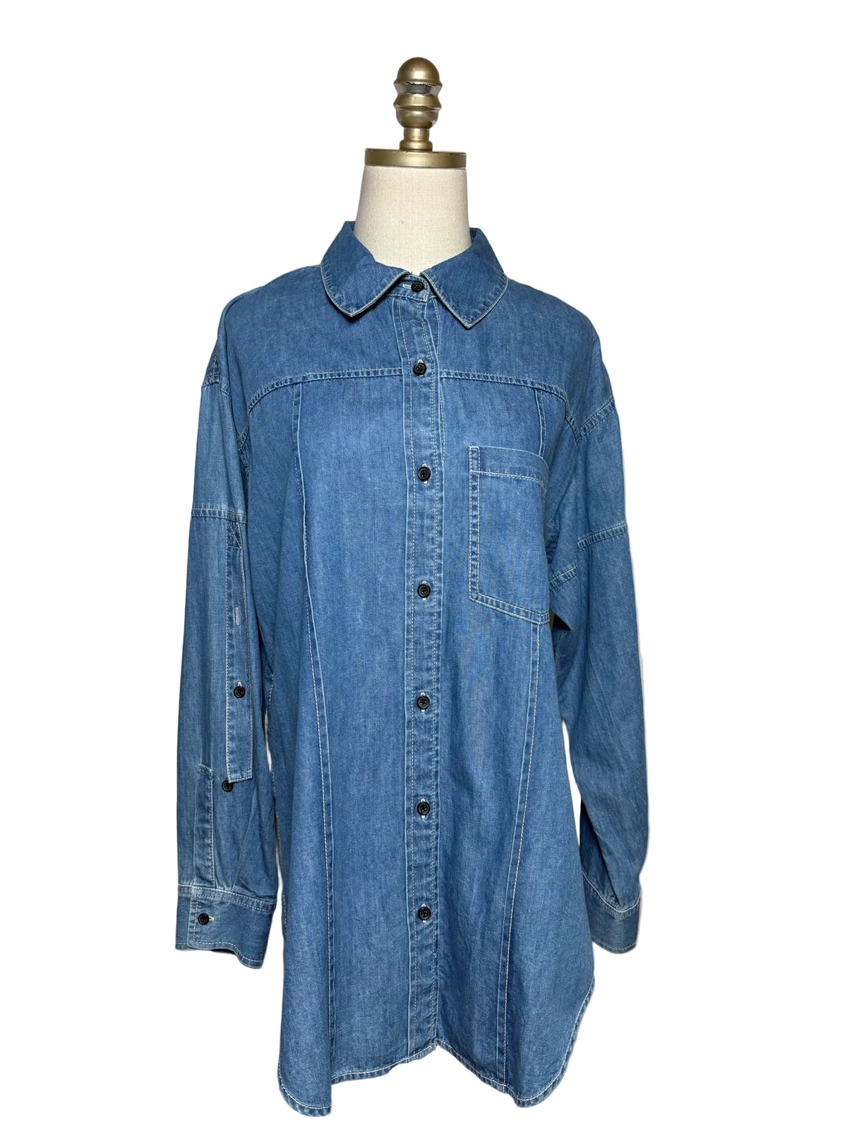 Blue denim button-up shirt on a mannequin on a white background