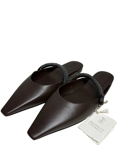 Brown Brunello Cucinelli slip-on mules with a tag.