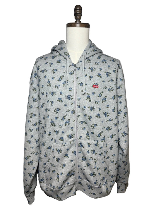 Grey Supreme hoodie with blue floral pattern and a red Supreme logo on left chest