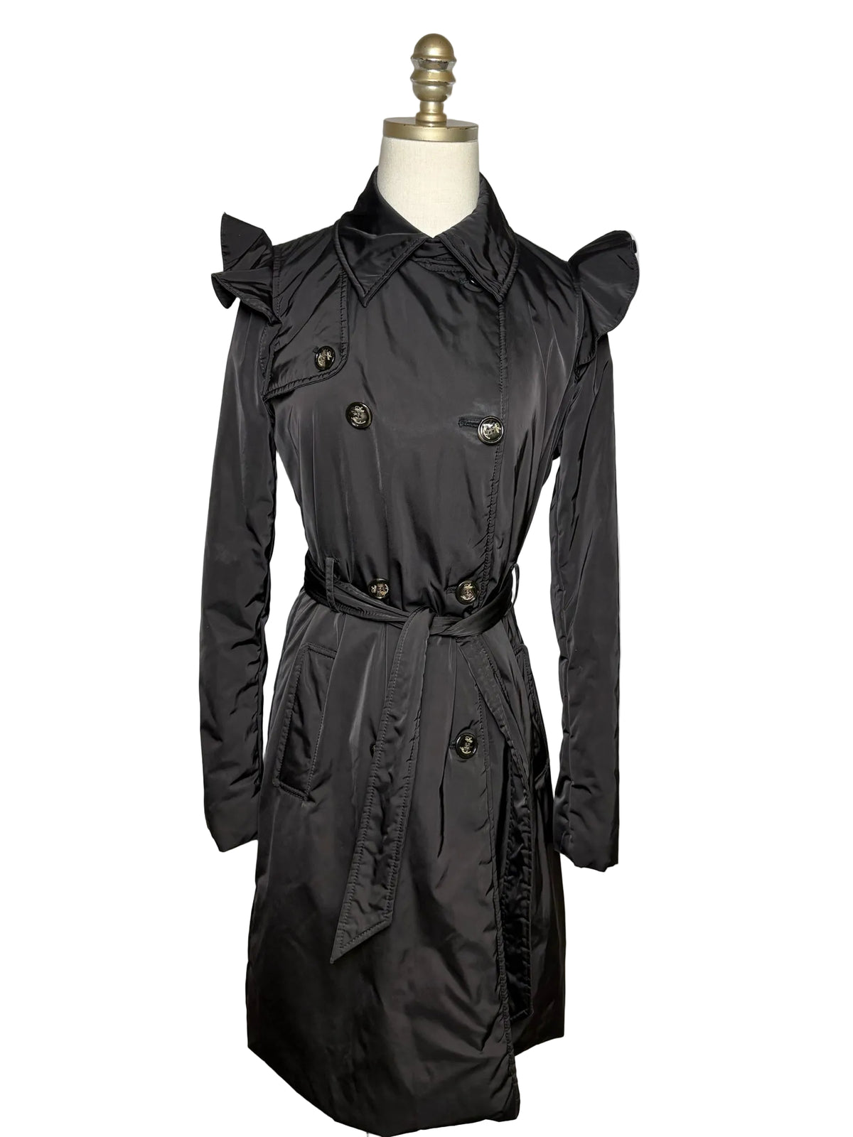 Black long jacket with a belt on a mannequin.