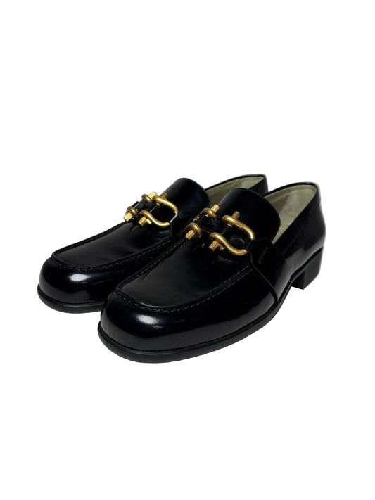 Black loafers with gold buckle
