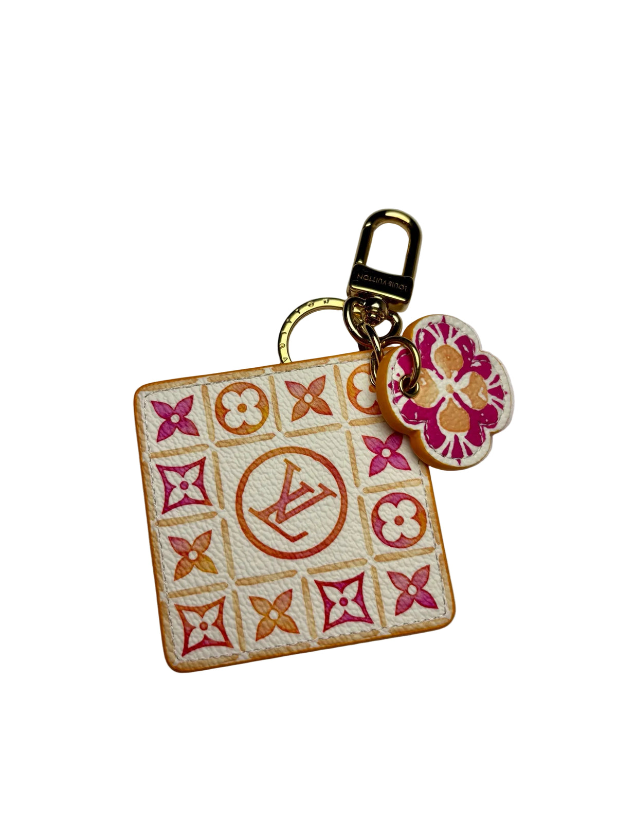 Louis Vuitton white square keychain with a pink and orange "LV" logo in the center surrounded by pink and orange monogram floral pattern.  There is also a pink and orange smaller flower keychain and both are attached to a gold key ring.