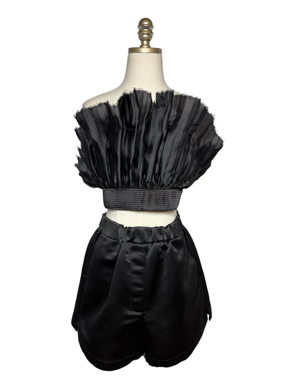 Mannequin wearing a black strapless silk top with black silk shorts.
