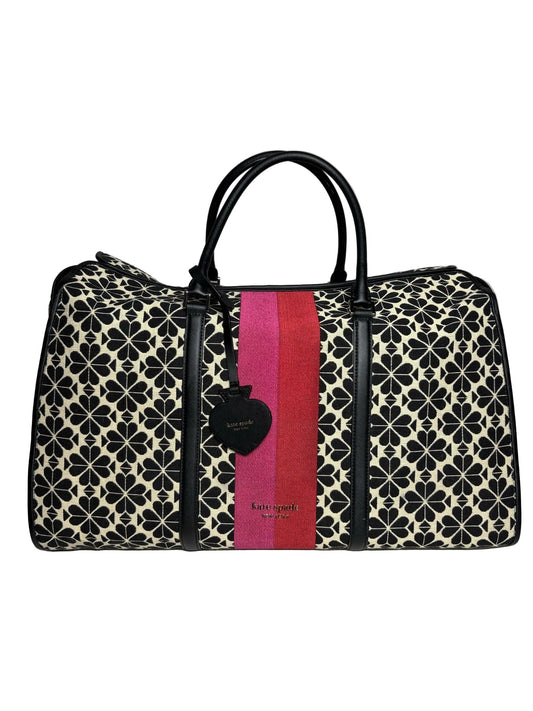Black and cream pattern canvas Kate Spade weekender bag with a pink and red strip accent down the middle.